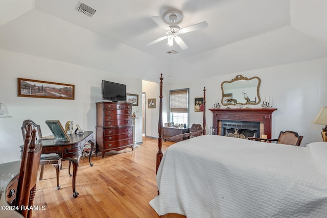 bedroom with vaulted ceiling, ceiling fan, and light hardwood / wood-style flooring