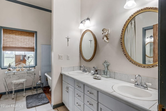 bathroom featuring a washtub, vanity, and tile patterned floors