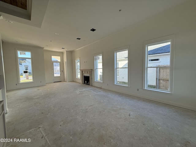 unfurnished living room featuring plenty of natural light