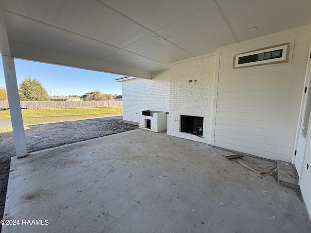 view of patio with an outdoor brick fireplace