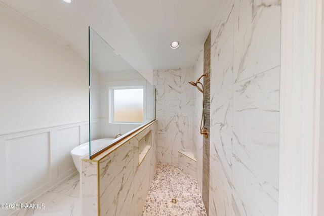 bathroom with marble finish floor, a marble finish shower, a decorative wall, and wainscoting