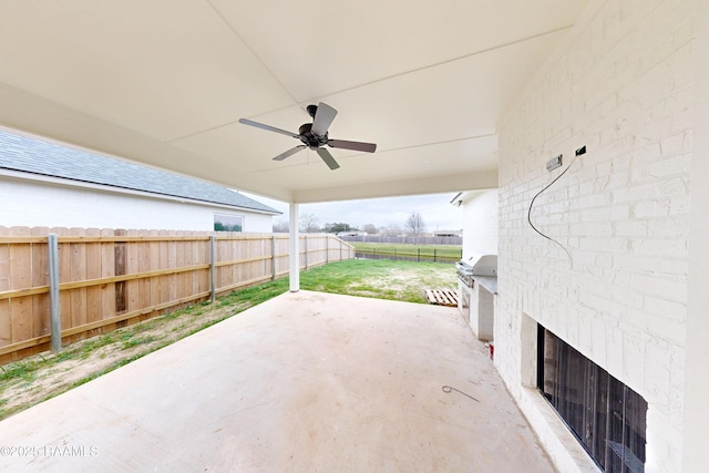 view of patio with a fenced backyard, a grill, and a ceiling fan