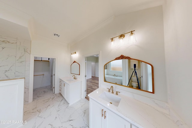 bathroom featuring marble finish floor, visible vents, two vanities, and a sink