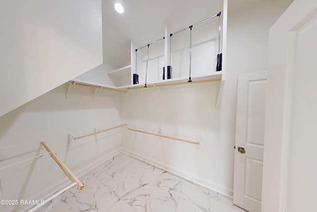 spacious closet with marble finish floor