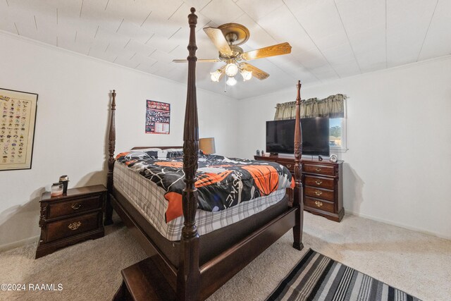 bedroom featuring light colored carpet, ceiling fan, and ornamental molding