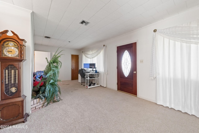 carpeted foyer entrance with crown molding