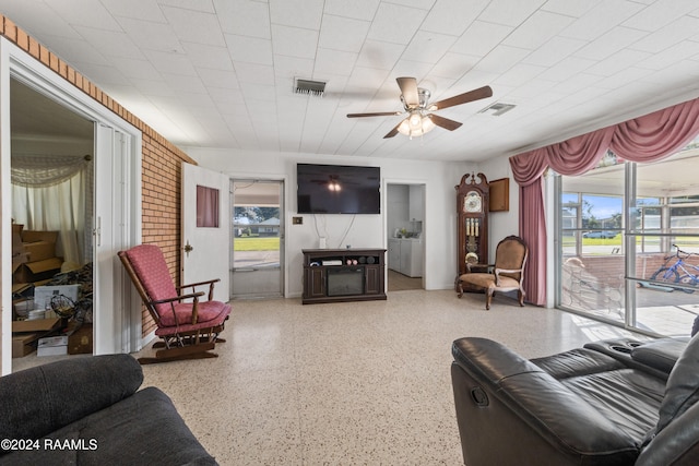 living room featuring ceiling fan and plenty of natural light