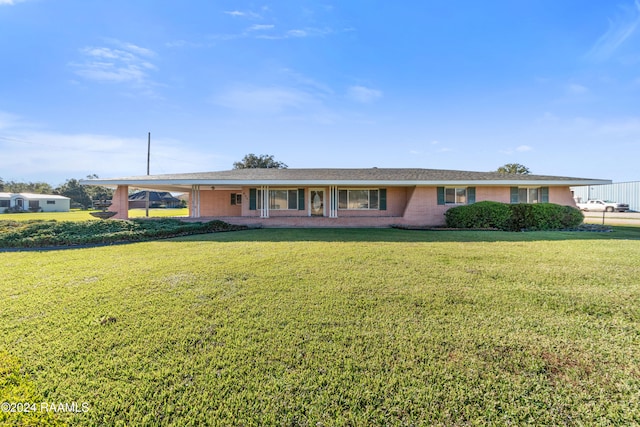 ranch-style home with a carport and a front yard