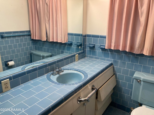 bathroom featuring vanity, toilet, and tile walls