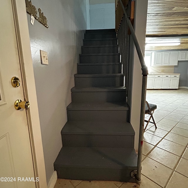 staircase with tile patterned floors