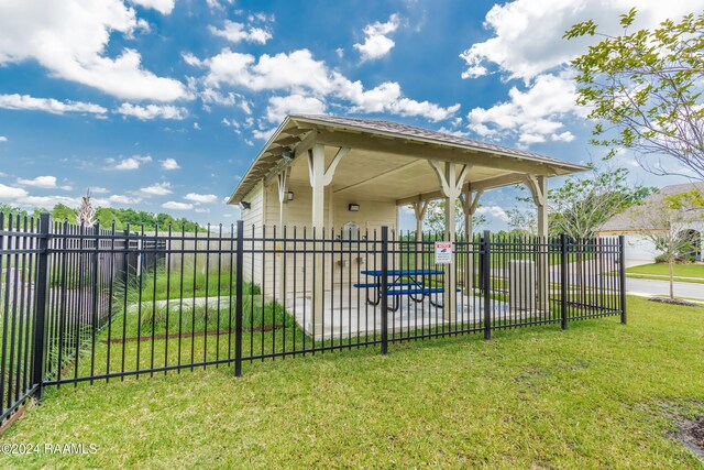 exterior space featuring a lawn and fence