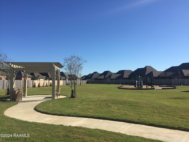 surrounding community with a residential view, a lawn, a pergola, and fence