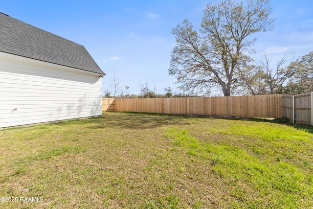 view of yard with a fenced backyard