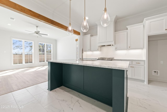 kitchen featuring ornamental molding, visible vents, marble finish floor, and a sink