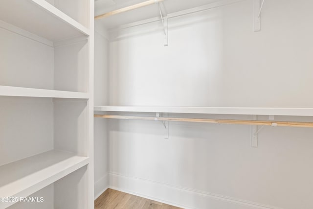 walk in closet featuring wood finished floors