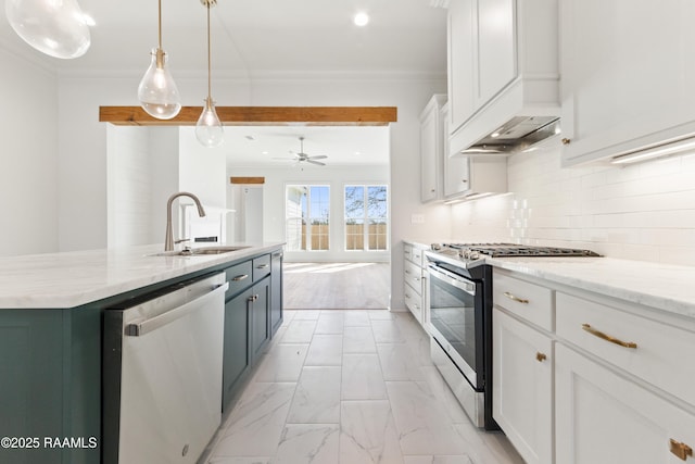 kitchen featuring ornamental molding, a sink, tasteful backsplash, stainless steel appliances, and white cabinets