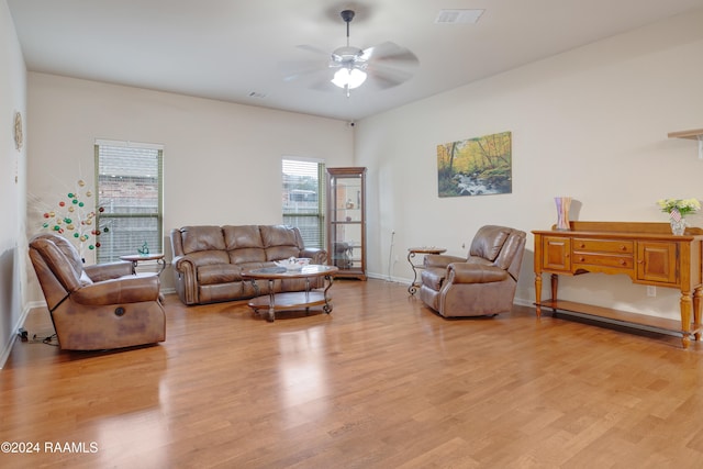 living room with light wood-type flooring and ceiling fan