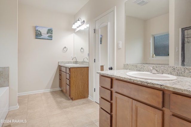 bathroom featuring vanity, tile patterned floors, and a bath