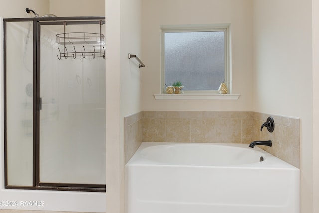 bathroom featuring independent shower and bath