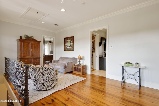 living room featuring ornamental molding and light hardwood / wood-style floors