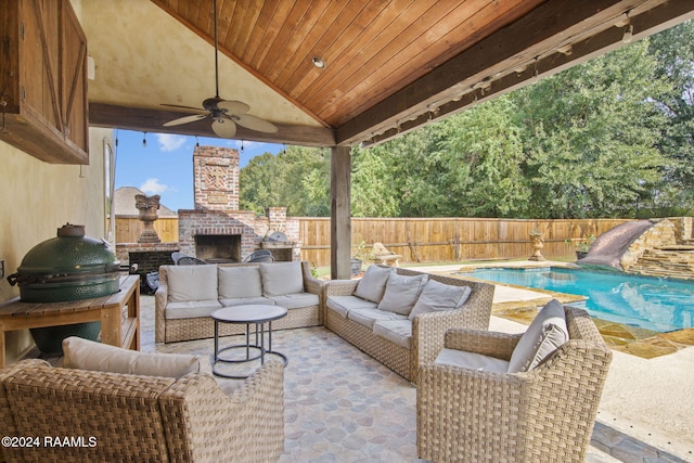 view of patio / terrace with ceiling fan, a fenced in pool, and an outdoor living space with a fireplace