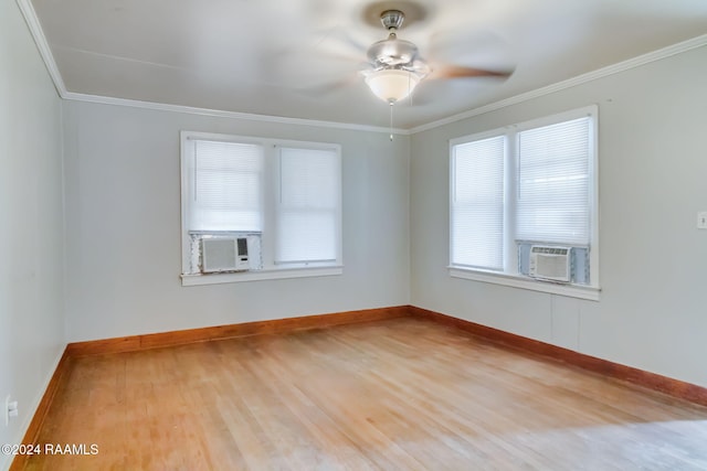 unfurnished room featuring a wealth of natural light, ceiling fan, cooling unit, and light wood-type flooring