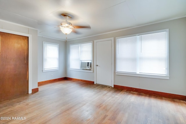 interior space featuring ceiling fan, cooling unit, light hardwood / wood-style flooring, and ornamental molding