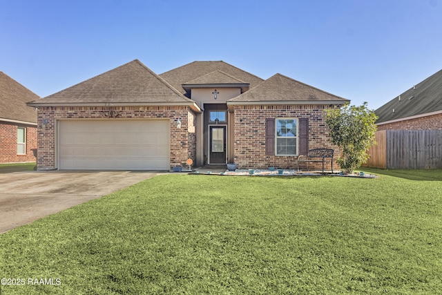 view of front of house with a front yard and a garage