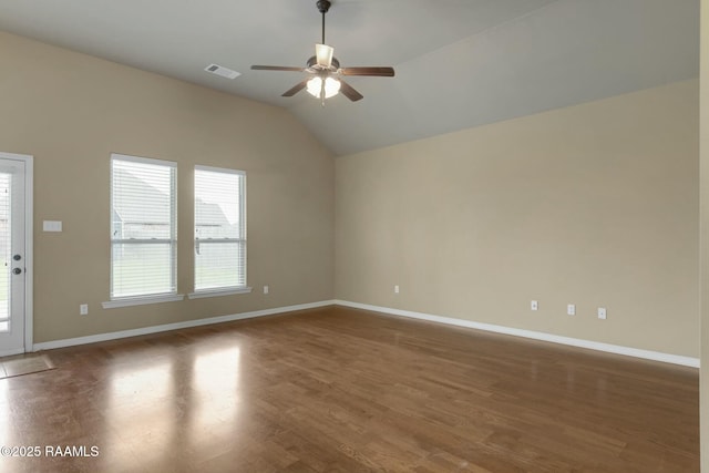 empty room with ceiling fan, dark wood-type flooring, and vaulted ceiling