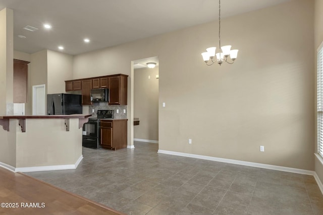 kitchen with a breakfast bar, black appliances, an inviting chandelier, tasteful backsplash, and pendant lighting