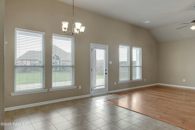 interior space featuring ceiling fan with notable chandelier and vaulted ceiling