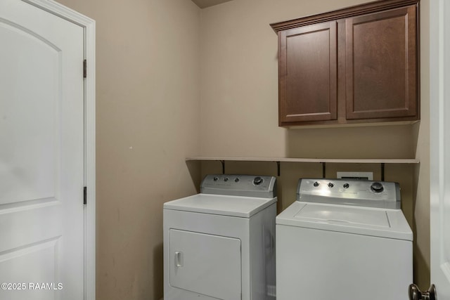 laundry room featuring cabinets and separate washer and dryer