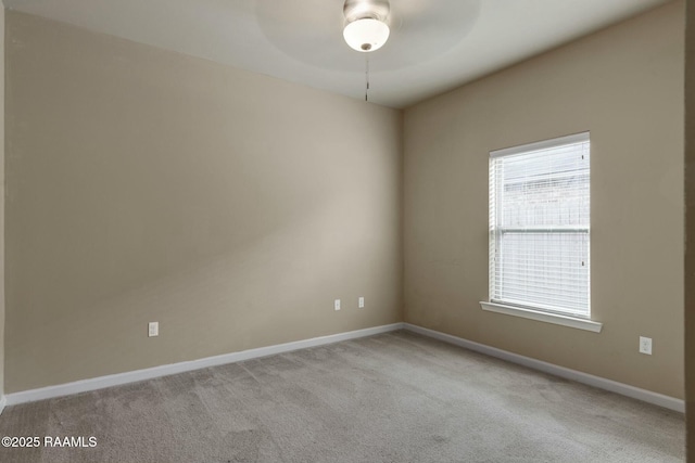 unfurnished room featuring light colored carpet and ceiling fan