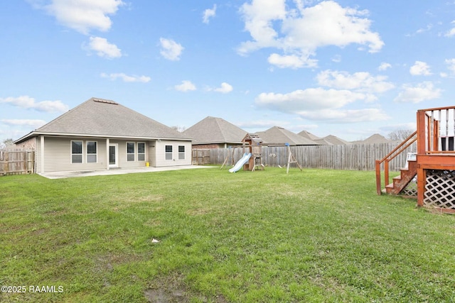 view of yard with a patio and a playground