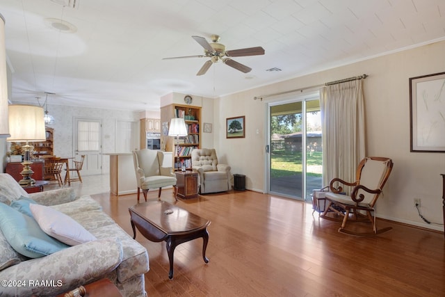 living room featuring ceiling fan, crown molding, and hardwood / wood-style floors