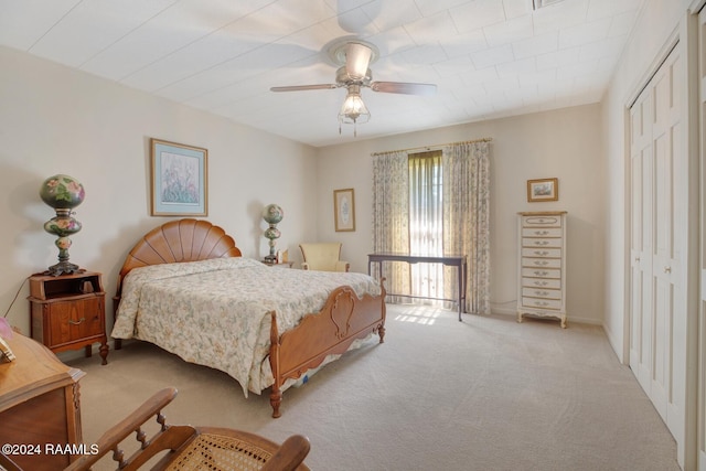 carpeted bedroom with a closet and ceiling fan