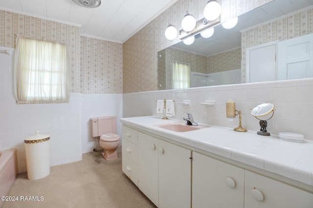 bathroom featuring vanity, a tub to relax in, toilet, and tile walls