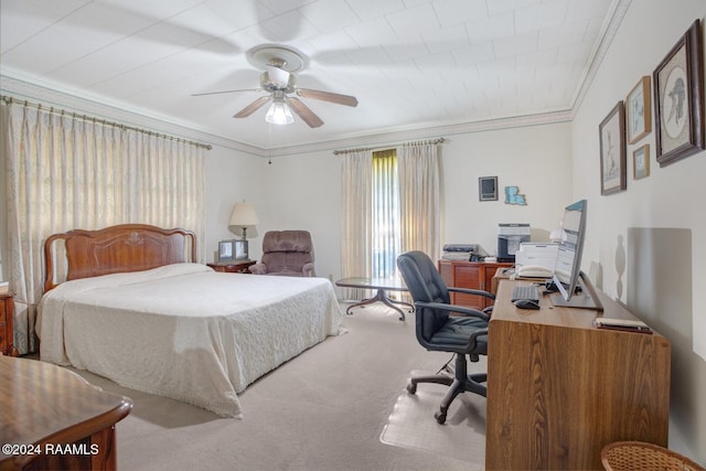 carpeted bedroom featuring crown molding and ceiling fan