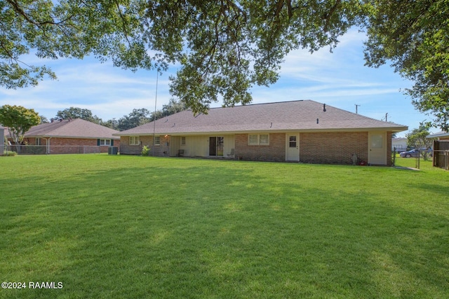 rear view of house with a yard