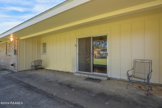 view of exterior entry featuring a patio area