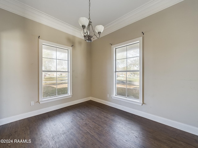 unfurnished room with a notable chandelier, dark hardwood / wood-style flooring, and ornamental molding