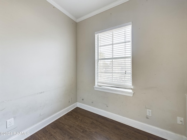 unfurnished room with plenty of natural light, dark hardwood / wood-style floors, and ornamental molding