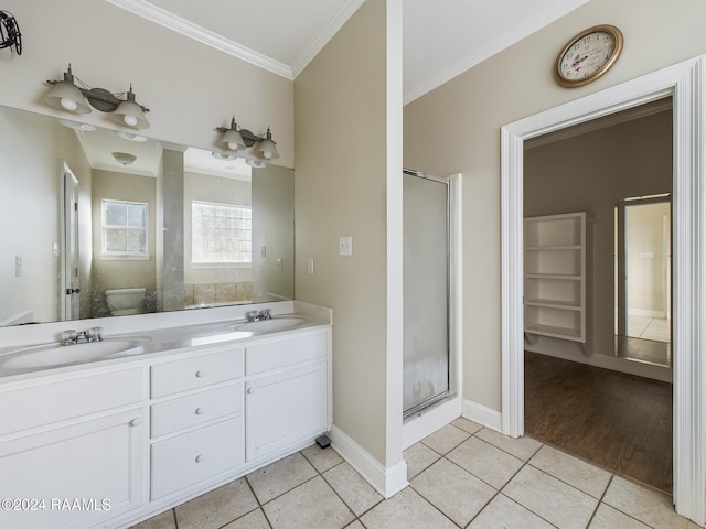 bathroom with vanity, tile patterned floors, a shower with shower door, and crown molding