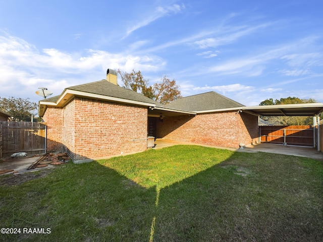 rear view of house with a patio area and a yard