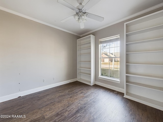 spare room with built in shelves, ceiling fan, dark hardwood / wood-style flooring, and crown molding