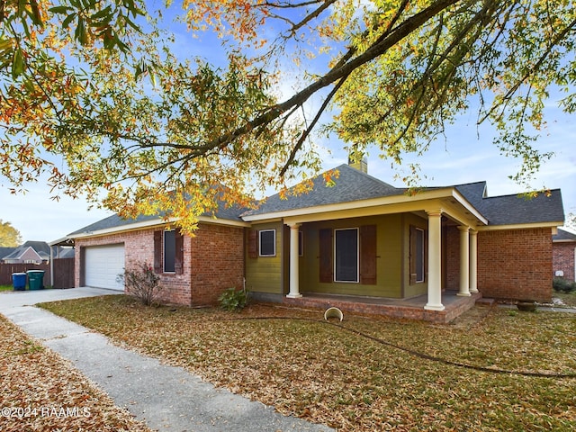 single story home featuring covered porch and a garage