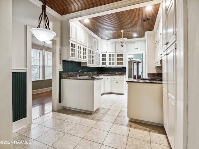 kitchen featuring ornamental molding, ceiling fan, decorative light fixtures, wood ceiling, and white cabinets