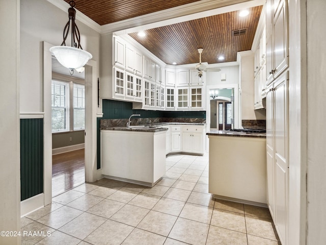 243 W Grolee St, Opelousas, LA 70570 - kitchen featuring wood ceiling, crown molding, dark countertops, white cabinetry, and a ceiling fan