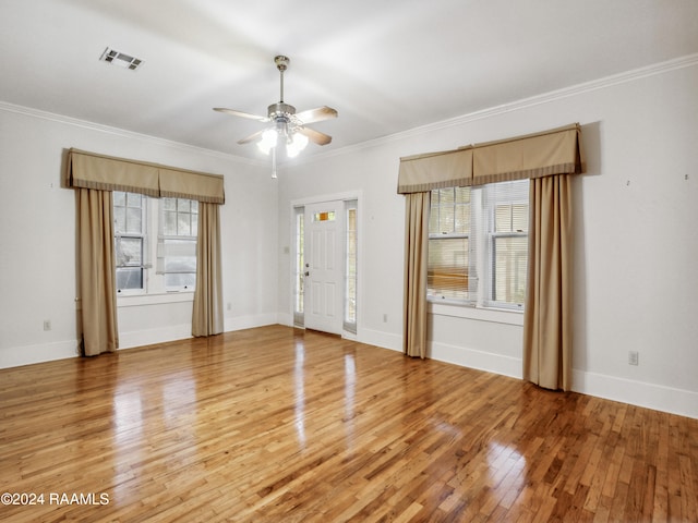 spare room featuring hardwood / wood-style flooring, ceiling fan, and ornamental molding