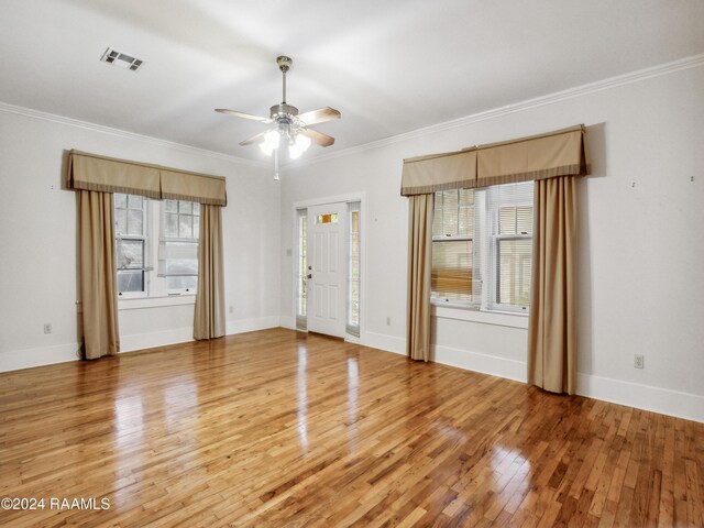 243 W Grolee St, Opelousas, LA 70570 - spare room with healthy amount of natural light, light wood-type flooring, ceiling fan, ornamental molding, and baseboards